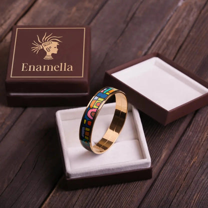 Yellow gold bracelet with the painting of Friedensreich Hundertwasser's "Spanish Nights" in a center. The bracelet is placed inside a square box