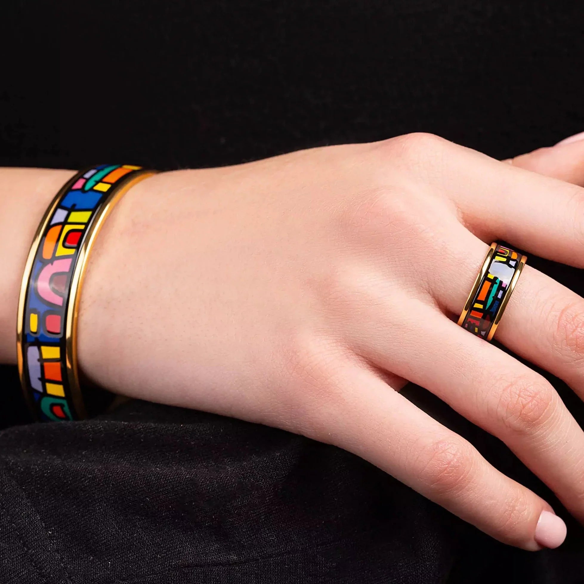 Load video: Yellow gold bracelet and yellow gold ring with the painting of Friedensreich Hundertwasser&#39;s &quot;Spanish Nights&quot; in a center. Jewelry is on a woman&#39;s hands