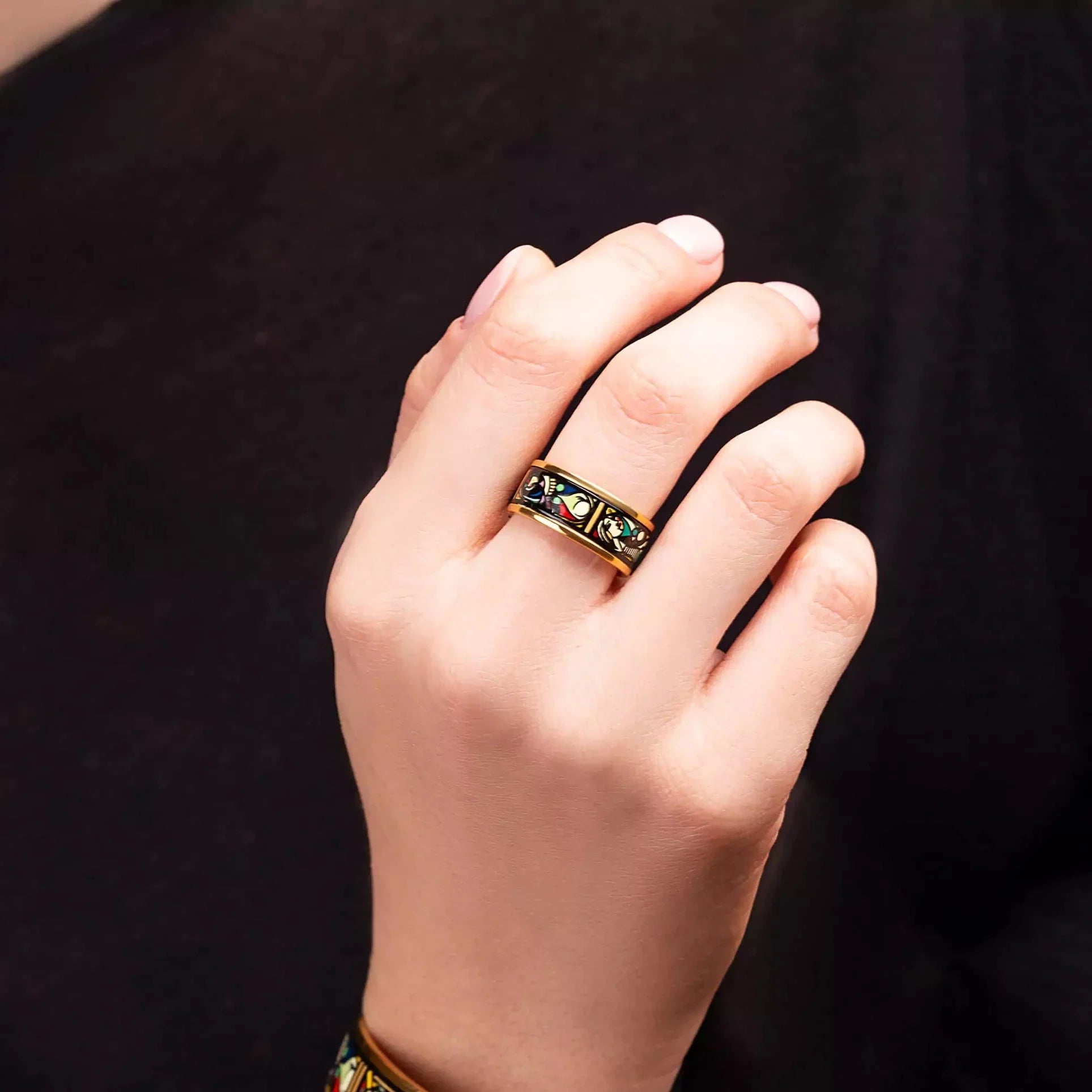 A hand with a bracelet and a ring from the Picasso's Secret collection.