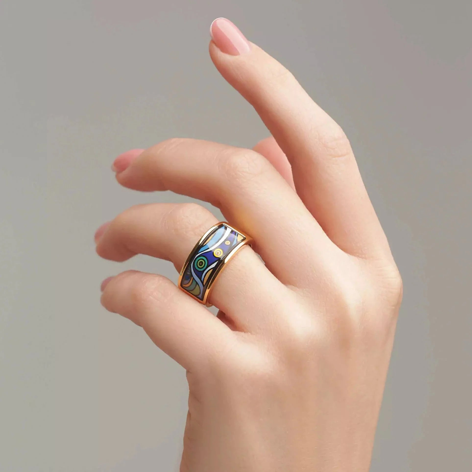 A woman's hand is wearing a ring from the Starry Night collection